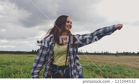 Beautiful girl dancing around in summer nature outside. Happy young woman outdoors. Playful woman in blue shirt turning around in summer nature outside. Beautiful girl dancing around in summer nature outside. Happy young woman outdoors. Playful woman in blue shirt turning around in summer nature outside. 131504532