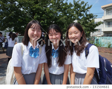 Three smiling high school girls in uniforms on their way to school Three smiling high school girls in uniforms on their way to school 131504681
