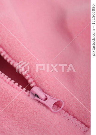 Metal zipper on pink fleece fabric. Clothing macro. Metal zipper on pink fleece fabric. Clothing macro. 131505080