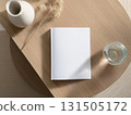 Books and a white book on the desk 131505172