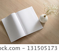 Books and a white book on the desk 131505173