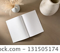 Books and a white book on the desk 131505174