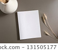 Books and a white book on the desk 131505177