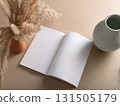 Books and a white book on the desk 131505179