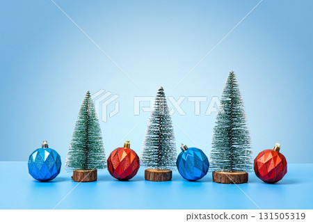 Christmas background with green tree and blue red Christmas balls on a blue table. Christmas and New Year design holiday card Christmas background with green tree and blue red Christmas balls on a blue table. Christmas and New Year design holiday card 131505319