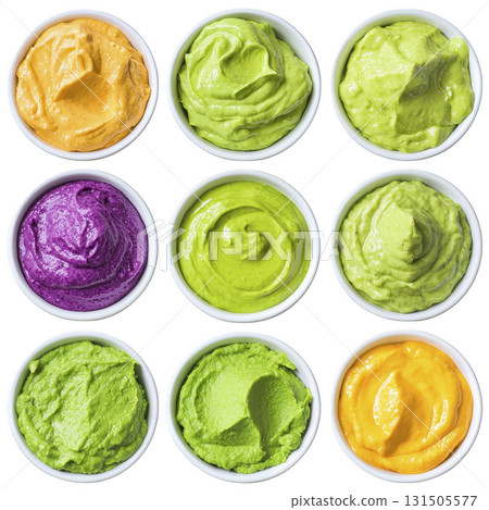 vibrant assortment of colorful sauces in small white bowls, featuring shades of green, yellow, and purple, arranged in grid pattern. creamy textures and bright colors create appetizing display 131505577
