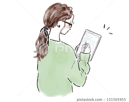 A smiling woman operating a tablet 131505955