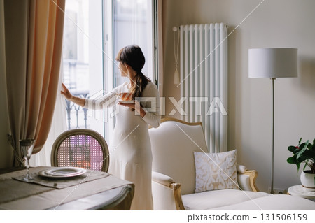 Woman drinking tea contemplating a Parisian morning view Woman drinking tea contemplating a Parisian morning view 131506159