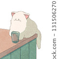 Cat trying to drop a cup 131506270