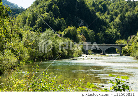 Beautiful Mountain Landscape in the Alps with Bridge over Clear River 131506831