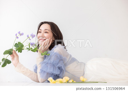 Portrait of woman with flowers 131506964