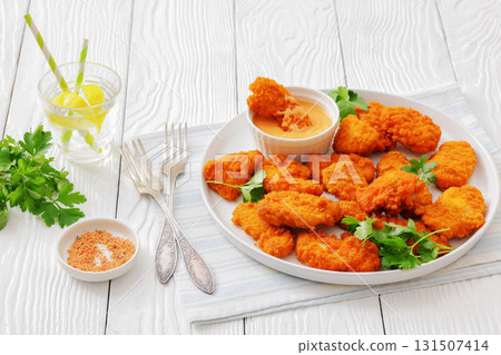 breaded chicken breast chunks with dipping sauce 131507414