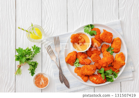 breaded chicken breast chunks with dipping sauce 131507419
