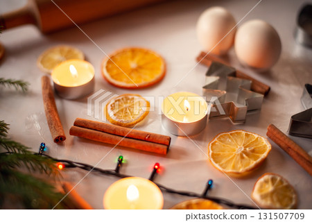 Still life shot of eggs, dried orange, cinnamon and different christmas decoration on the table. Warm festive Christmas mood 131507709