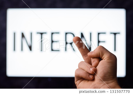 Conservant man has no interest to use modern technologies shows middle finger to a screen with inscription INTERNET Conservant man has no interest to use modern technologies shows middle finger to a screen with inscription INTERNET 131507770