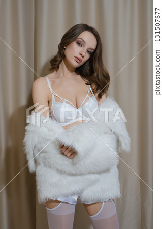 Elegant woman in white lingerie poses in hotel boudoir setting Elegant woman in white lingerie poses in hotel boudoir setting 131507877