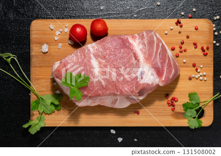 Raw Meat with Tomatoes and Parsley on Cutting Board 131508002