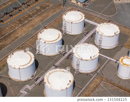 Seven white storage tanks at industrial site during daytime Seven white storage tanks at industrial site during daytime 131508125