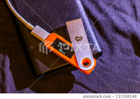 hardware Bitcoin wallet on black fabric 131508148