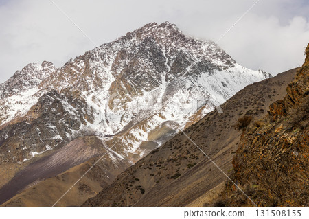 Dramatic snow-covered mountains in vast cold landscape at springtime day 131508155