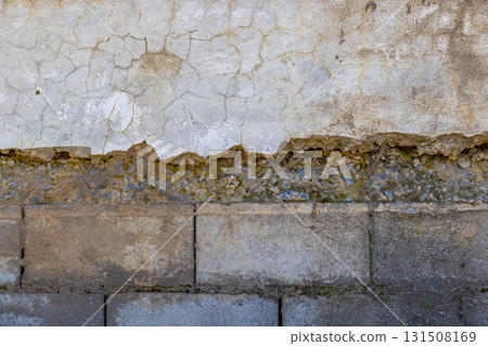 Weathered plastered and brick wall showing damage under sun light Weathered plastered and brick wall showing damage under sun light 131508169