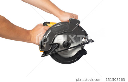 A powerful electric hand-held circular saw in a man's hands, isolated on a white background, close-up. Woodworking tool, industry 131508263