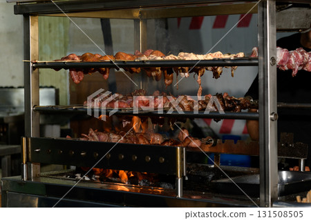 Mixed roast meat cooking over open flames. Mixed roast meat cooking over open flames. 131508505