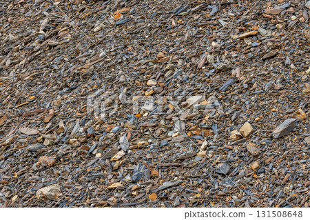 Scattered sharp crushed rocks on rocky hillside during daytime 131508648