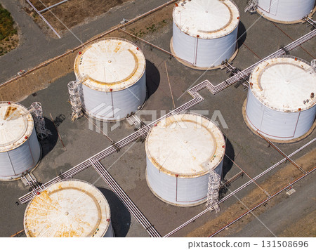 Industrial fuel storage tanks in outdoor facility during daytime 131508696