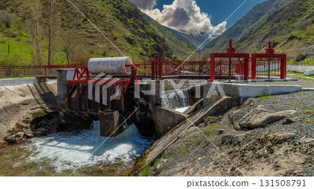 Water Control Structure Flowing in Serene Mountainous Region Water Control Structure Flowing in Serene Mountainous Region 131508791