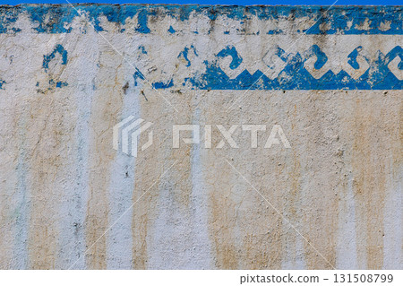 Weathered outdoor wall with textured paint and discoloration 131508799