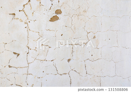 Cracked weathered whitewashed plastered wall showing age in outdoor setting Cracked weathered whitewashed plastered wall showing age in outdoor setting 131508806