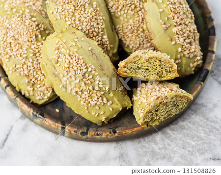 Matcha madeleine cookies with white chocolate frosting on marble background 131508826