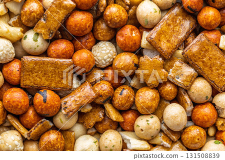 Salted snack. Coated peanuts and mini crackers. Top view. Salted snack. Coated peanuts and mini crackers. Top view. 131508839