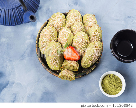 Matcha madeleine cookies with white chocolate frosting and sesame seeds Matcha madeleine cookies with white chocolate frosting and sesame seeds 131508842