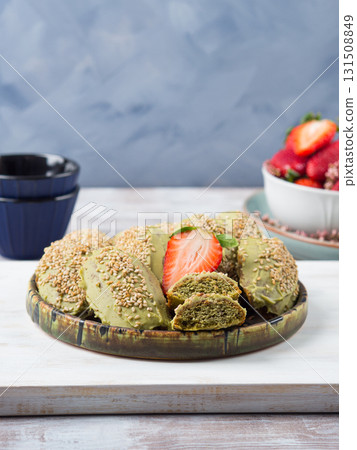 Matcha madeleine cookies with white chocolate frosting and sesame seeds Matcha madeleine cookies with white chocolate frosting and sesame seeds 131508849