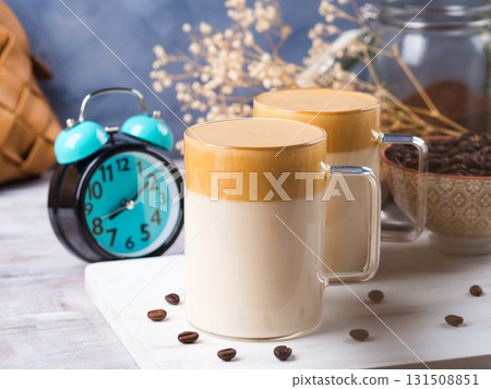 Latte morning drink with whipped coffee cream on wooden board 131508851