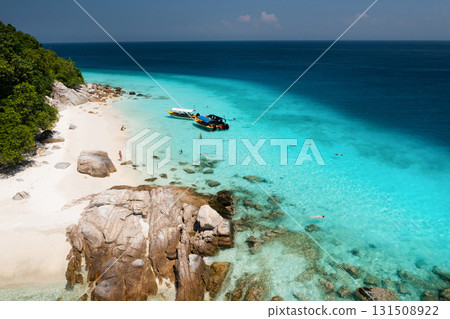 A beautiful tropical beach on the island of Lang Tengah in Malaysia with clear turquoise water and large stones on a sunny day 131508922
