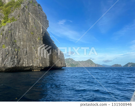 A large rock formation with a blue sky in the background. A large rock formation with a blue sky in the background. 131508946