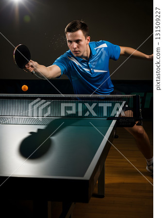 Dynamic action shot of a man playing table tennis 131509227