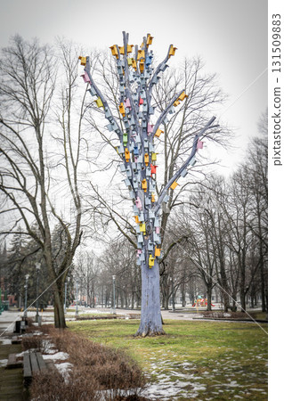 Colorful Birdhouses Decorate Tree Trunk in Public Park Colorful Birdhouses Decorate Tree Trunk in Public Park 131509883