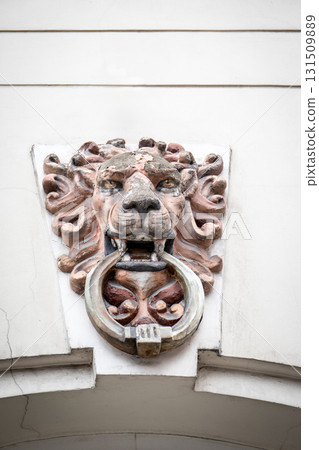 Decorative Lion Head Door Knocker on Building Wall 131509889