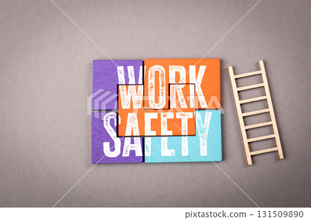 Work Safety Message with Wooden Blocks and Ladder on Gray Surface Work Safety Message with Wooden Blocks and Ladder on Gray Surface 131509890
