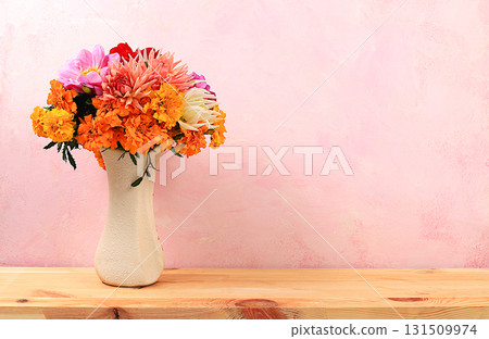 Beautiful dahlia and marigold flowers in a vase, abstract floral arrangement, autumn background with space for text, minimal holiday concept, still life, postcard. Happy birthday, wedding, selective 131509974