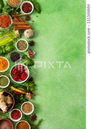 Fresh, fragrant spices and herbs arranged in an array of colors, sitting on a soft green backdrop, bringing flavor and zest to any kitchen, top view and copy space Fresh, fragrant spices and herbs arranged in an array of colors, sitting on a soft green backdrop, bringing flavor and zest to any kitchen, top view and copy space 131509984
