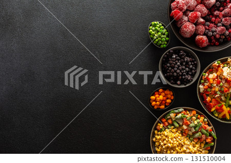 A variety of frozen vegetables and fruits arranged in plates, set against a dark background, capturing the essence of summer preservation for winter meals A variety of frozen vegetables and fruits arranged in plates, set against a dark background, capturing the essence of summer preservation for winter meals 131510004