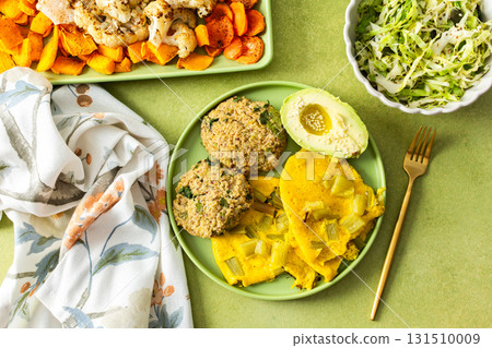 Enjoy a vibrant breakfast featuring scrambled eggs with rhubarb, fluffy quinoa pancakes, creamy avocado drizzled with olive oil, roasted vegetables, and a refreshing fresh salad 131510009