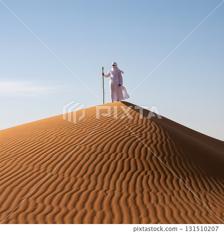 Desert Traveler Standing Atop a Sand Dune Desert Traveler Standing Atop a Sand Dune 131510207