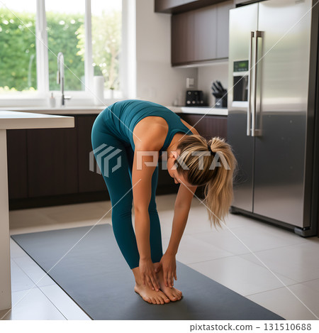 Woman Doing Standing Forward Fold Stretch in a Kitchen 131510688