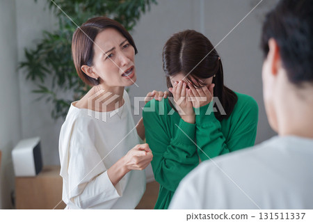 A woman gets angry at a man who made her friend cry A woman gets angry at a man who made her friend cry 131511337